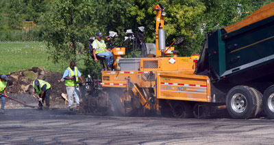 August 10, 2009 - Our expanded parking lot is being paved today.
